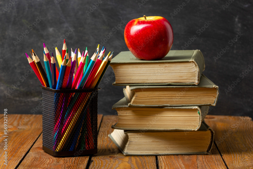 Back to school. Education background with books and apple over blackboard Back to school. Education background with books and apple over blackboard