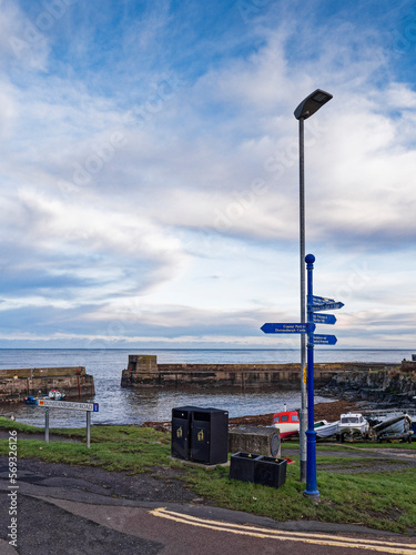 Craster harbour in Northumberland, UK with signpost and copy space