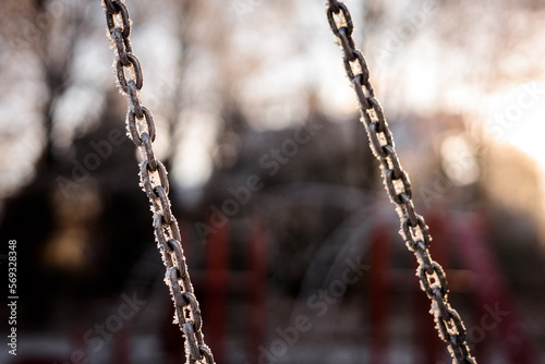 frozen swing on a playground © Przemyslaw