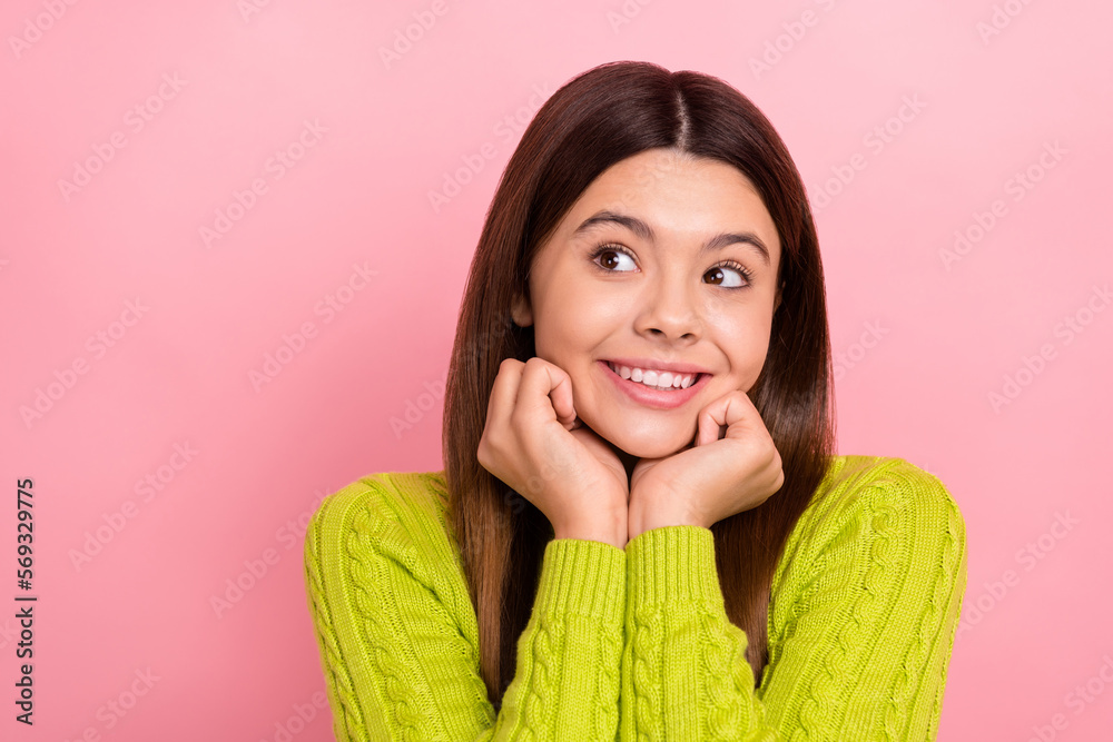 Photo portrait of pretty young schoolgirl fists touch face look empty space dressed stylish green outfit isolated on pink color background Photo portrait of pretty young schoolgirl fists touch face look empty space dressed stylish green outfit isolated on pink color background