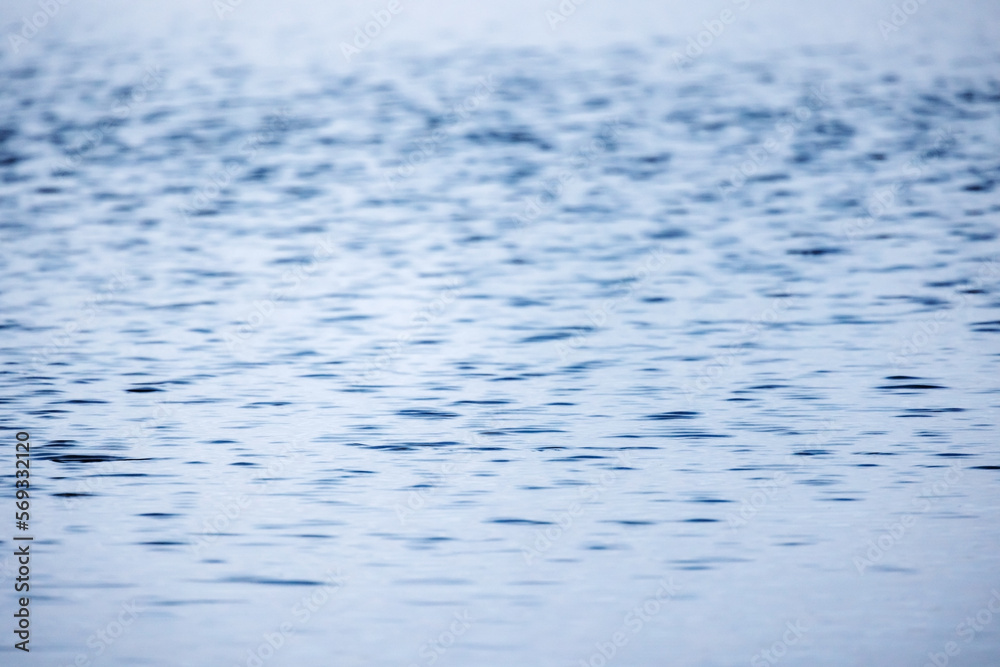 Blue still water surface with ripple pattern, natural background texture Blue still water surface with ripple pattern, natural background texture