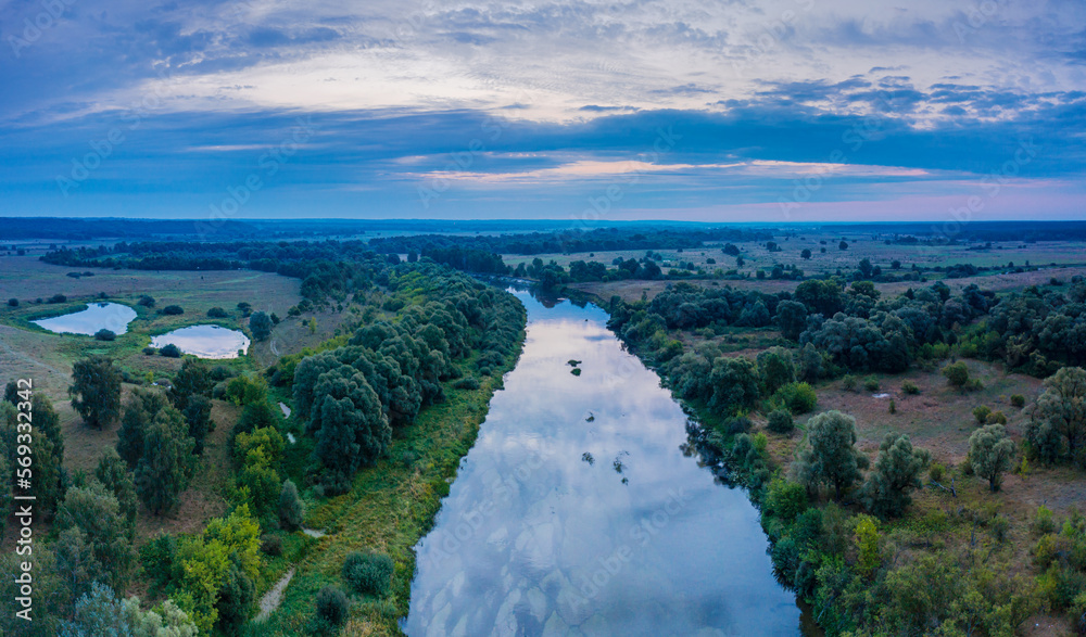 Obraz premium Beautiful Ukrainian nature background. Drone view on riverbank of the Seym river and amazing cloudscape over it. Summertime.