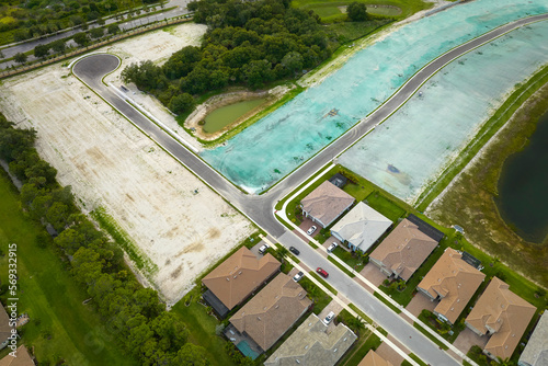 Aerial view of construction site with new tightly packed homes in Florida closed living clubs. Family houses as example of real estate development in american suburbs