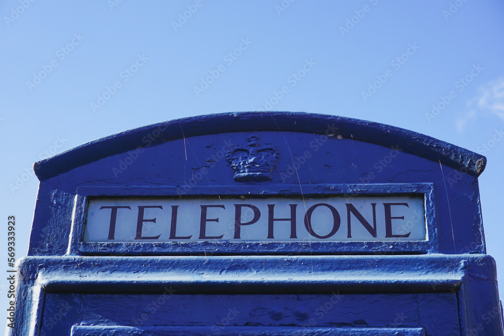 vintage British telephone kiosk. Rare blue painted phone box. public pay phone sign 