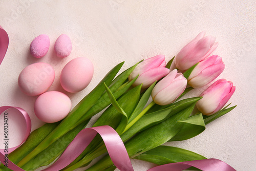 Fototapeta Naklejka Na Ścianę i Meble -  Composition with bouquet of beautiful tulip flowers, painted Easter eggs and ribbon on light background