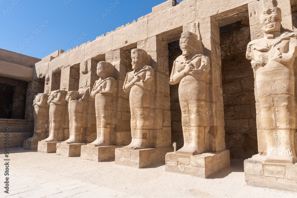 Statues and columns in the Luxor temple on a sunny day.