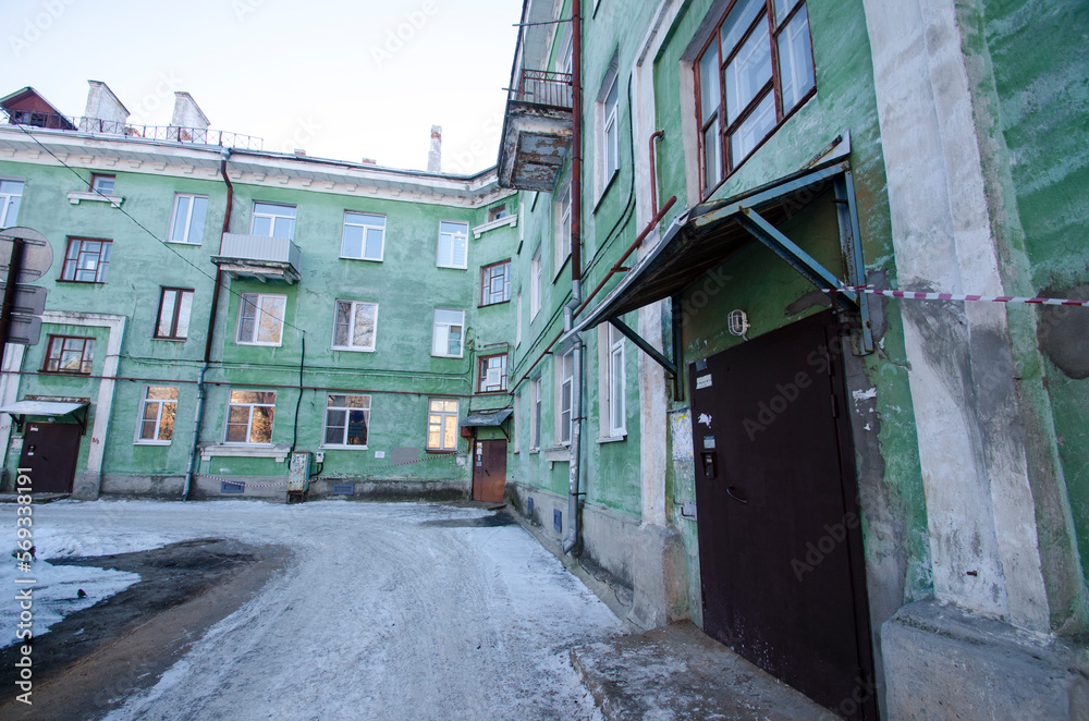 A cozy courtyard in the city of Severodvinsk. Soviet architecture. green facade