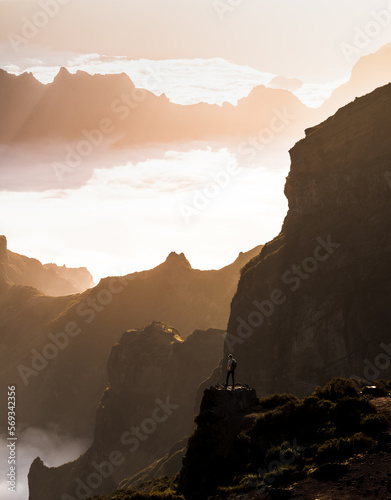 Pico do Arieiro is the third highest peak on Madeira Island and is one of the most popular sunrise spots.,a view from a drone of a landscape shrouded in clouds