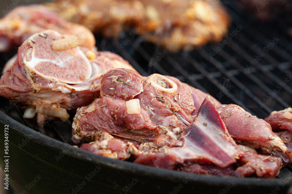 Cooking different meat on barbecue. Grilled and roasted lamb steaks on bbq Cooking different meat on barbecue. Grilled and roasted lamb steaks on bbq