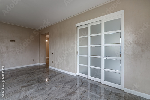 Empty house with marble floor with white French doors