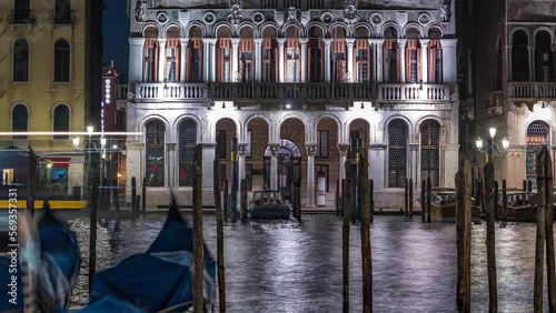 The magnificent Palazzo Balbi overlooking the Grand Canal in Venice night timelapse. Gondolas on foreground. Now home to the President and local government of the Veneto region of Italy. photo