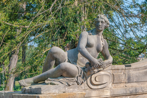 Ancient decayed statue of a sensual bathing Renaissance Era woman in the central city park of Potsdam, a German town of statues and sculptures, Germany
