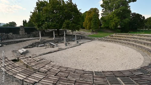 Budapest, Hungary. August 2022. Footage at the Roman archaeological site of Aquincum. The tilt movement shows the amphitheater. Beautiful summer day. photo