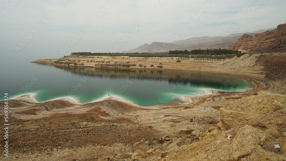 Dead Sea panoramic view with salt on shores and clear water, Jordan and Israel, Dead Sea