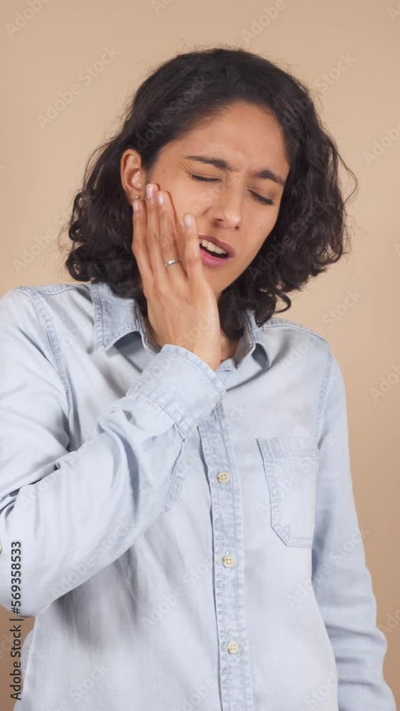 vertical video of young latin woman, with strong toothache. vertical video of young latin woman, with strong toothache.