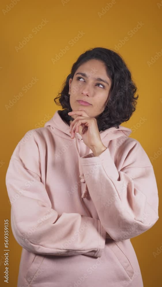 vertical video of young latin woman,thinking and imagining great ideas vertical video of young latin woman,thinking and imagining great ideas