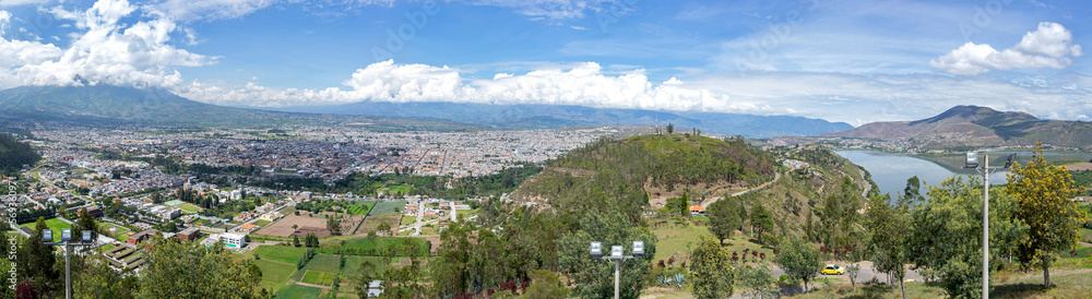 Panoramic view of the city of Ibarra, Yahuarcocha lake and surrounding Andean mountains and forests. Ibarra, Imbabura Province, Ecuador