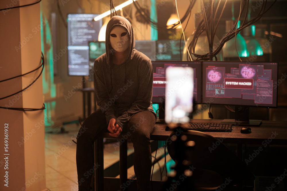 Obraz premium Cyber criminal in mask hacking password, breaking into computer system, anonymous attacking data server. Cybercrime, woman hacker stealing information portrait at night time
