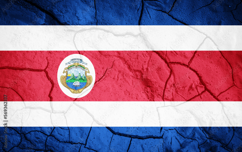 Flag of Costa Rica. Costa Rica symbol. Flag on the background of dry cracked earth. Costa Rica flag with drought concept