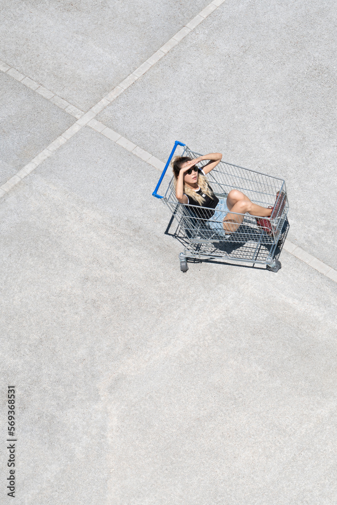 Portrait of a young asian woman having fun sitting inside of a shoopping mall view from top Portrait of a young asian woman having fun sitting inside of a shoopping mall view from top