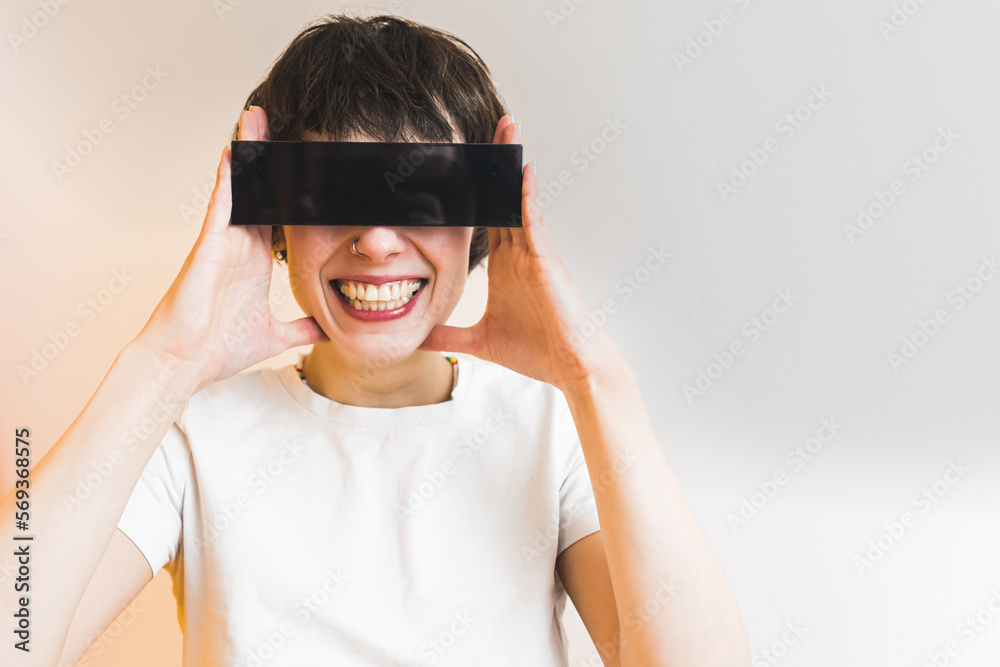 Fashionable eyewear concept. Short-haired female model smiling at camera wearing rectangular sunglasses. White background. High quality photo Fashionable eyewear concept. Short-haired female model smiling at camera wearing rectangular sunglasses. White background. High quality photo