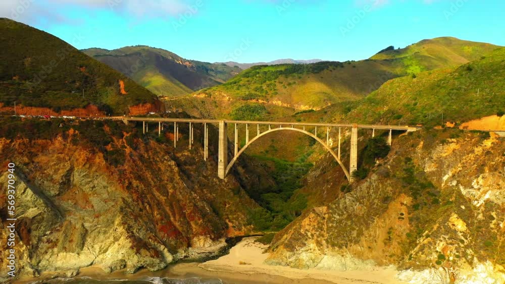 Aerial Backward Shot Of Bixby Creek Bridge By Sea And Mountains Against Sky - San Francisco, California Aerial Backward Shot Of Bixby Creek Bridge By Sea And Mountains Against Sky - San Francisco, California