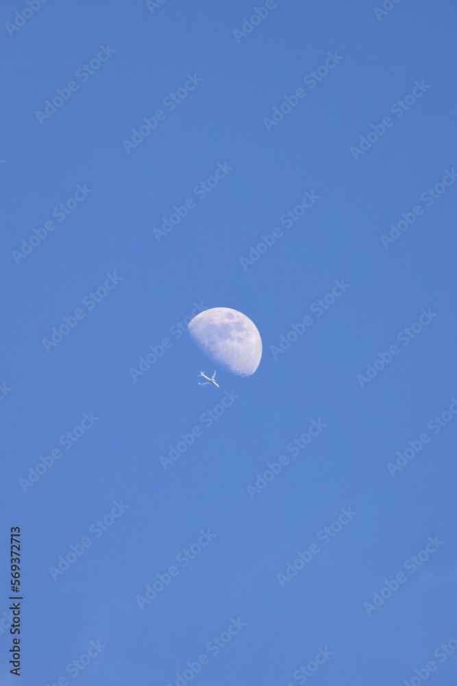 A Jet Flying Under a Full Moon at Night, Color Image A Jet Flying Under a Full Moon at Night, Color Image