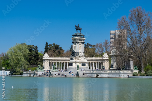 Madrid, Spain. April 6, 2022: Sculpture in the middle of a fountain in El Retiro park and blue sky.