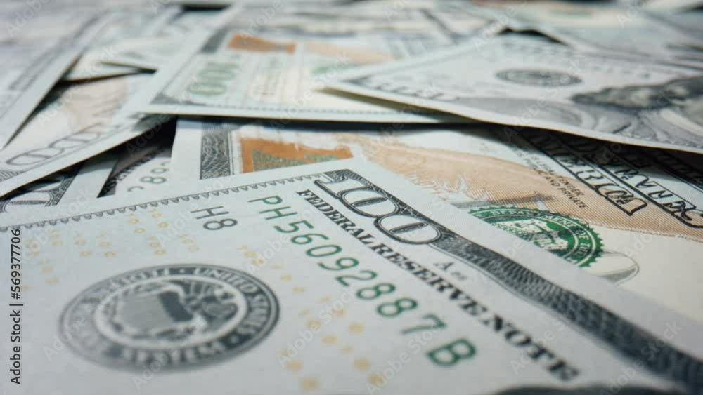 Paper hundred dollar bills on surface close up. American currency scattered. Paper hundred dollar bills on surface close up. American currency scattered.