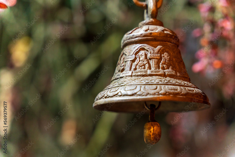 Old bronze bell in indian temple with blur background. Hindu temple brass  bell hanging in gold color Stock Photo