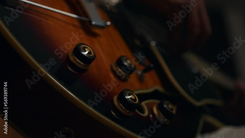 close up of a person playing a gibson guitar