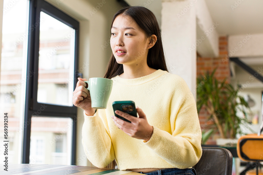 asian pretty woman with a coffee cup at cool home asian pretty woman with a coffee cup at cool home