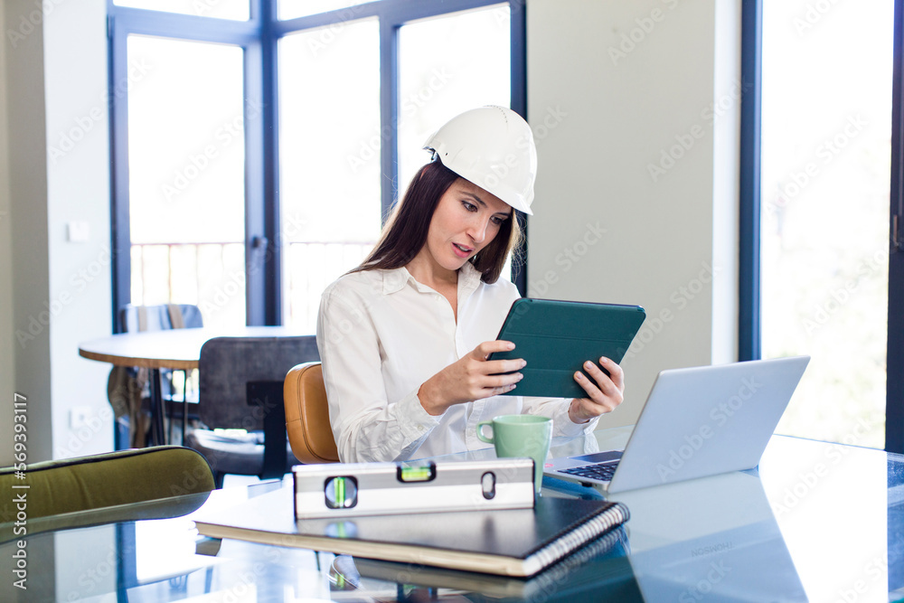 young adult pretty architect woman working at office with a laptop young adult pretty architect woman working at office with a laptop