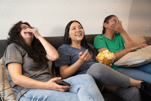 Latin women laughing on the sofa