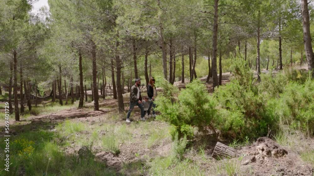 Family strolls through Mediterranean bush in springtime Family strolls through Mediterranean bush in springtime