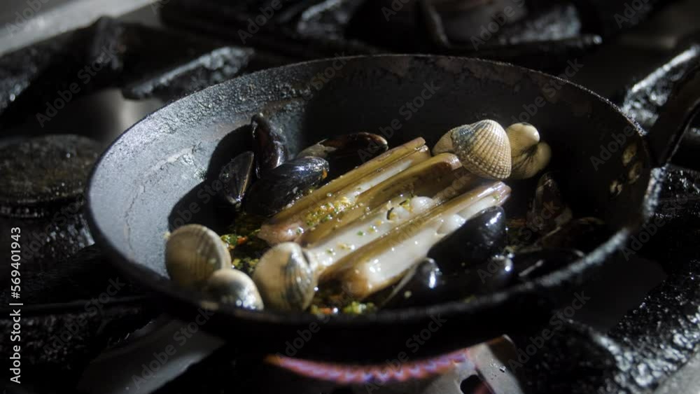 Mussels and seafood cooking in pan with herbs Mussels and seafood cooking in pan with herbs