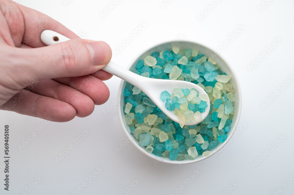 Top view of natural sea salt in bowl on white background. Top view of natural sea salt in bowl on white background.