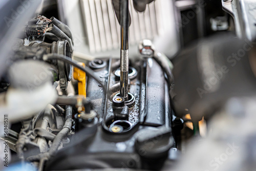 Change spark plugs at an auto-differential service shop.