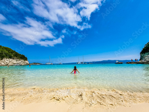 A Girl Enters Azure Waters. Turquoise Beach Sea View, blue sky and white clouds