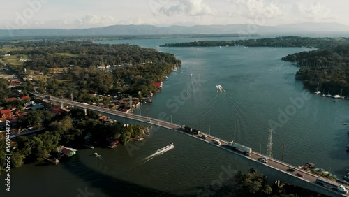 Traffic Over The Longest Bridge At Guatemala In Rio Dulce, Izabal. Aerial Drone Shot photo