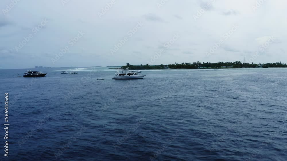 Aerial Forward Shot Of White Nautical Vessels Floating On Waves In Sea Under Cloudy Sky - Thulusdhoo, Maldives Aerial Forward Shot Of White Nautical Vessels Floating On Waves In Sea Under Cloudy Sky - Thulusdhoo, Maldives