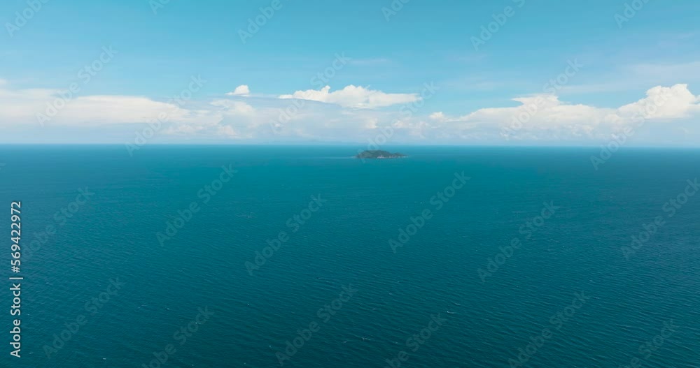 Aerial drone of blue sea and tropical island Apo against blue sky and clouds. Philippines. Aerial drone of blue sea and tropical island Apo against blue sky and clouds. Philippines.
