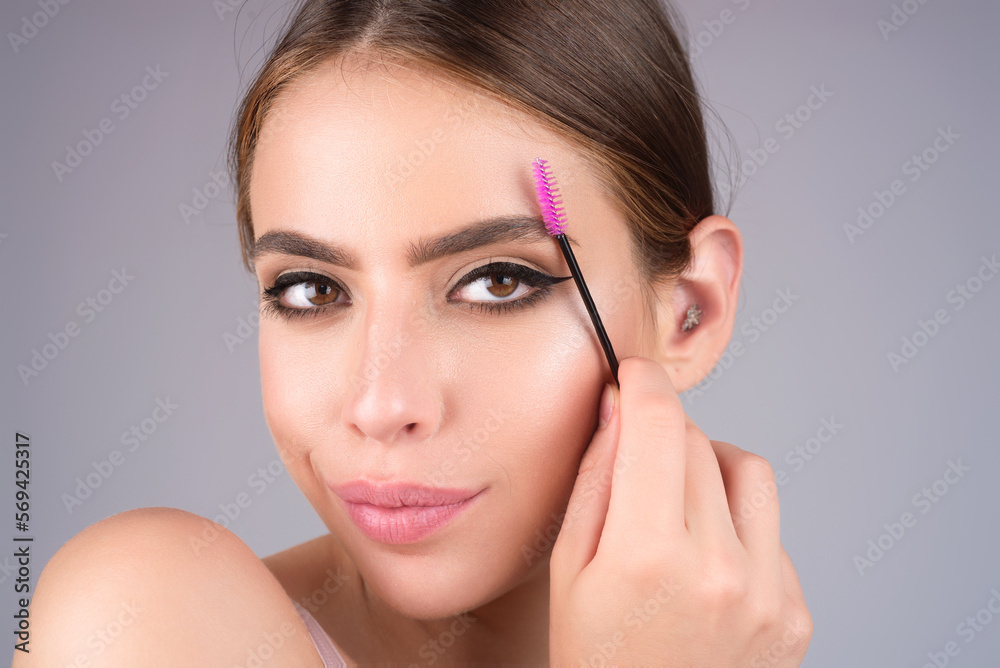 Beautiful woman with perfect shape eyebrows. Womans brows close up. Beautiful girl with eyebrow brush. Eyebrow correction. Long eyelashes and thick eyebrows. Beautiful woman with perfect shape eyebrows. Womans brows close up. Beautiful girl with eyebrow brush. Eyebrow correction. Long eyelashes and thick eyebrows.