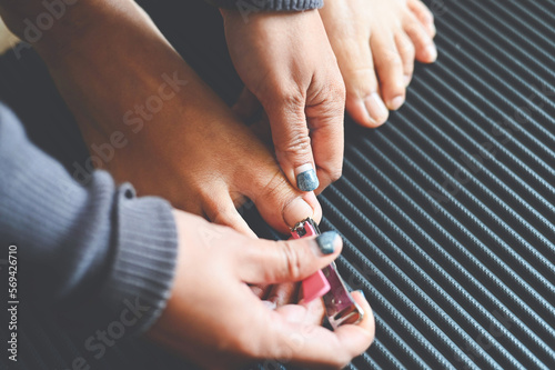 Cut toenails cut nails concept  woman hand holding nail clipper and cutting nails foot - pedicure nail health care