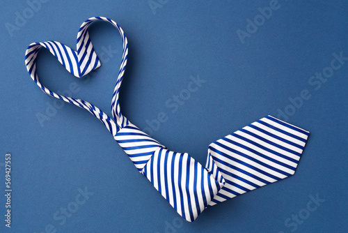 Photographie Necktie in heart shape on blue background