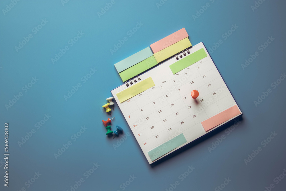 Closeup calendar page with drawing-pins , planning for business meeting or travel planning concept Closeup calendar page with drawing-pins , planning for business meeting or travel planning concept