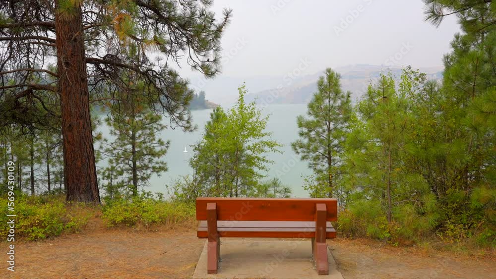 Establishing shot of Picnic Table in Park with mountain lake background in slow motion at summer day in Vancouver, Canada, North America. Day time on September 2022. Still camera. Establishing shot of Picnic Table in Park with mountain lake background in slow motion at summer day in Vancouver, Canada, North America. Day time on September 2022. Still camera.
