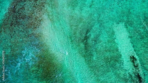 Aerial Top Upward Shot Of Turquoise Waves Splashing Towards Beach - Thulusdhoo, Maldives photo