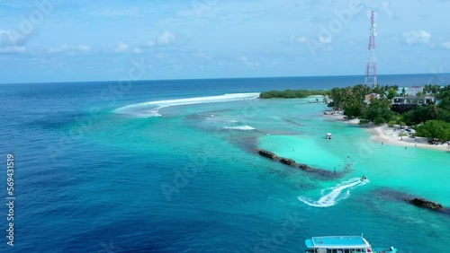 Aerial Beautiful View Of Trees On Island Against Clouds, Drone Flying Forward Over Sea During Sunny Day - Thulusdhoo, Maldives photo