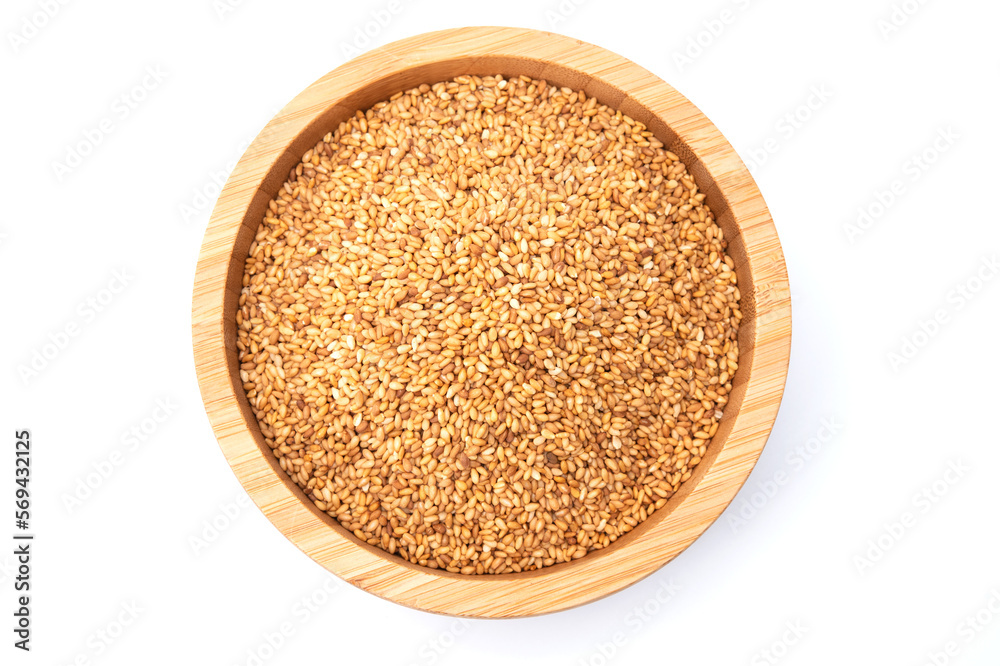 Top view of golden sesame seeds in wooden bowl isolated on white background Top view of golden sesame seeds in wooden bowl isolated on white background